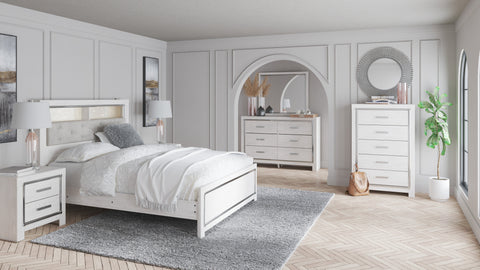 Altyra White Upholstered LED Bookcase Panel Bedroom Set